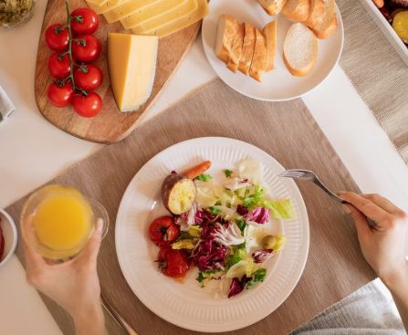 Top view of a delicious homemade meal with cheese, salad, and assorted ingredients.